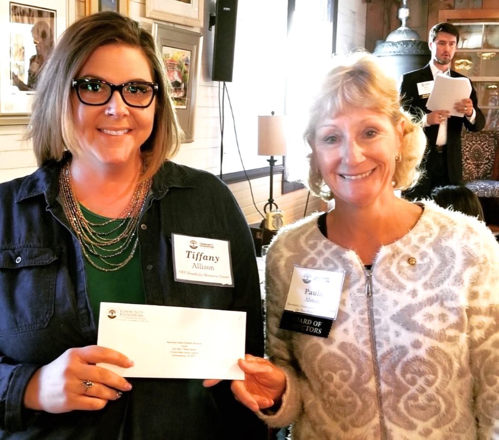 NRV DRC's Community Advocate, Tiffany Allison, accepts the grant awarded from Board of Directors, Paula Alston, with the Community Foundation of the NRV.
